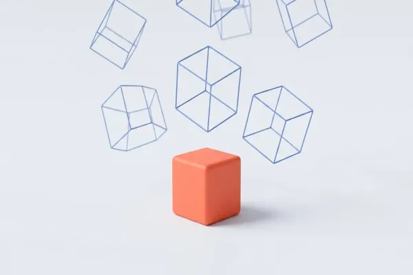 Un cubo naranja macizo, posado en el suelo y con su sombra, rodeado de seis cubos dibujados solo con líneas azules que flotan en el aire sin tocar el suelo.